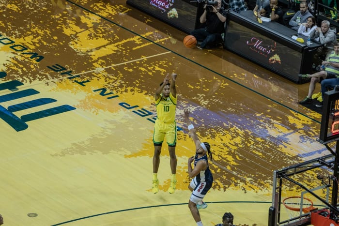 Kwame Evans Jr. sinking a three-pointer over an Arizona defender.